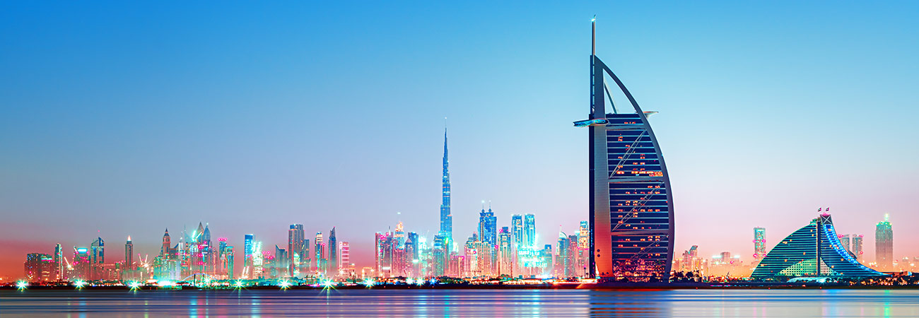 Dubai - amazing city center skyline and famous Jumeirah beach at sunset, United Arab Emirates